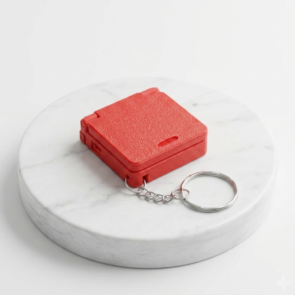 A small textured red plastic case with a silver metal keychain, displayed on a round white marble riser against a clean white background.